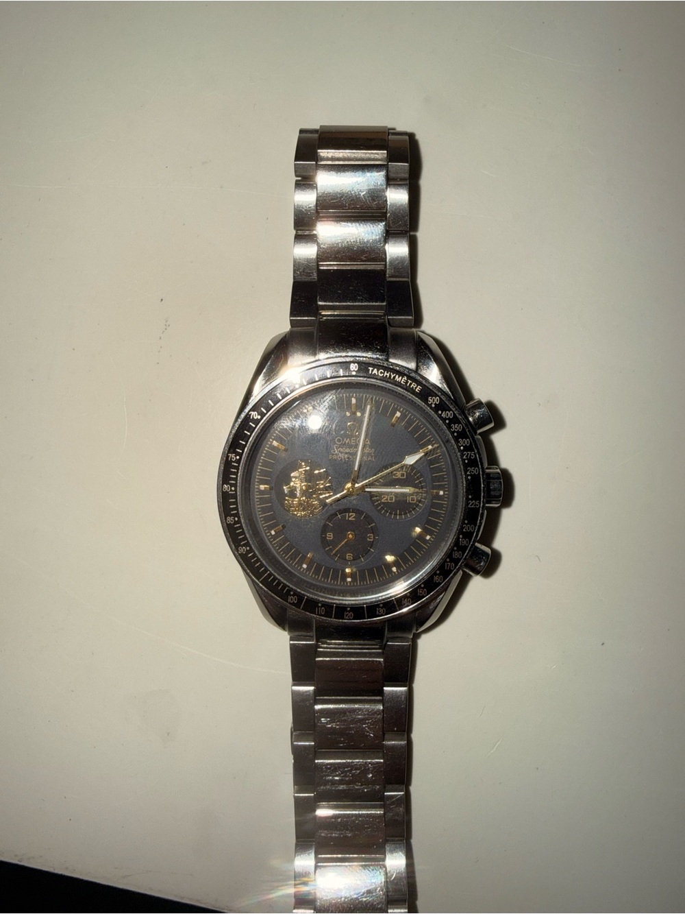 Omega Stainless Steel Chronograph Watch with Black Dial and Gold Accents